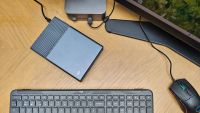 Photos of a silver grey HD box on a wooden desk