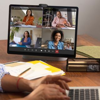 video call device on a desk with a split screen four-way call