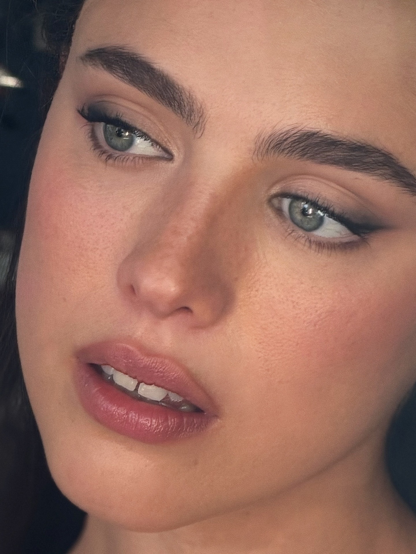 A close-up of Margaret Qualley's makeup, featuring a smokey wing