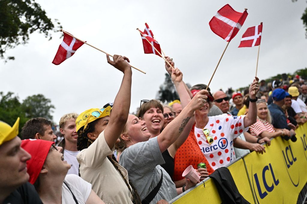 Spectators wave Danish flags along the race route before the start of the 1st stage of the 109th edition of the Tour de France cycling race 132 km individual time trial stage in Copenhagen on July 1 2022 Photo by Marco BERTORELLO AFP Photo by MARCO BERTORELLOAFP via Getty Images