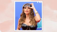 Sofía Vergara is pictured lifted her black sunglasses away from her eyes whilst attending the "America's Got Talent" Season 19 Red Carpet at Pasadena Civic Auditorium on March 26, 2024 in Pasadena, California/ in a pink watercolour template