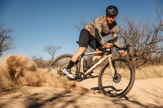 A cyclist skidding the rear end of the Enve MOG and kicking up dirt on a trail