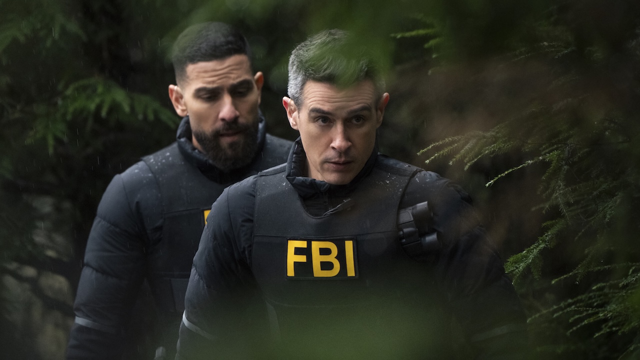 OA and Scola sneaking through the woods in CBS' FBI Season 8 winter premiere