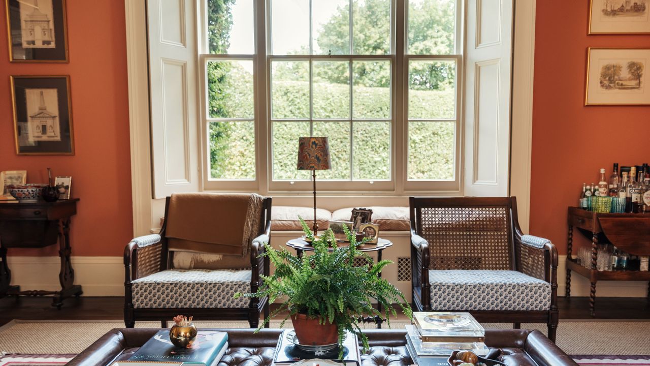 orange living room with two grey armchairs