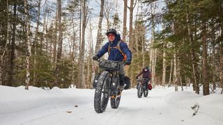 Two riders in the snow on the Trek Farley fat tire mountain bike