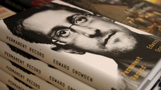 Edward Snowden's face on a pile of books