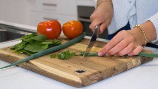 Vegetables being prepared on a wooden chopping board