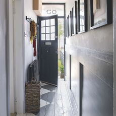 hallway with brown door and white walls