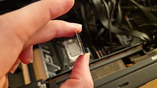 A reviewer showcasing how thin the WD Blue SN5000 4TB SSD is