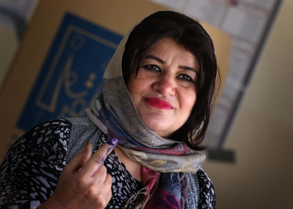 An Iraqi woman shows she has voted