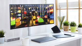 One of the best ultrawide monitors, on an office desk surrounded by plants