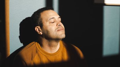Man practices breathing exercise