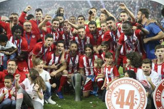 Olympiacos players celebrate in May 2017 after winning a seventh consecutive Greek title.