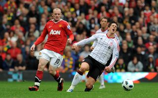 Torres goes to ground after a challenge by Manchester United’s Wayne Rooney at Old Trafford in September 2010