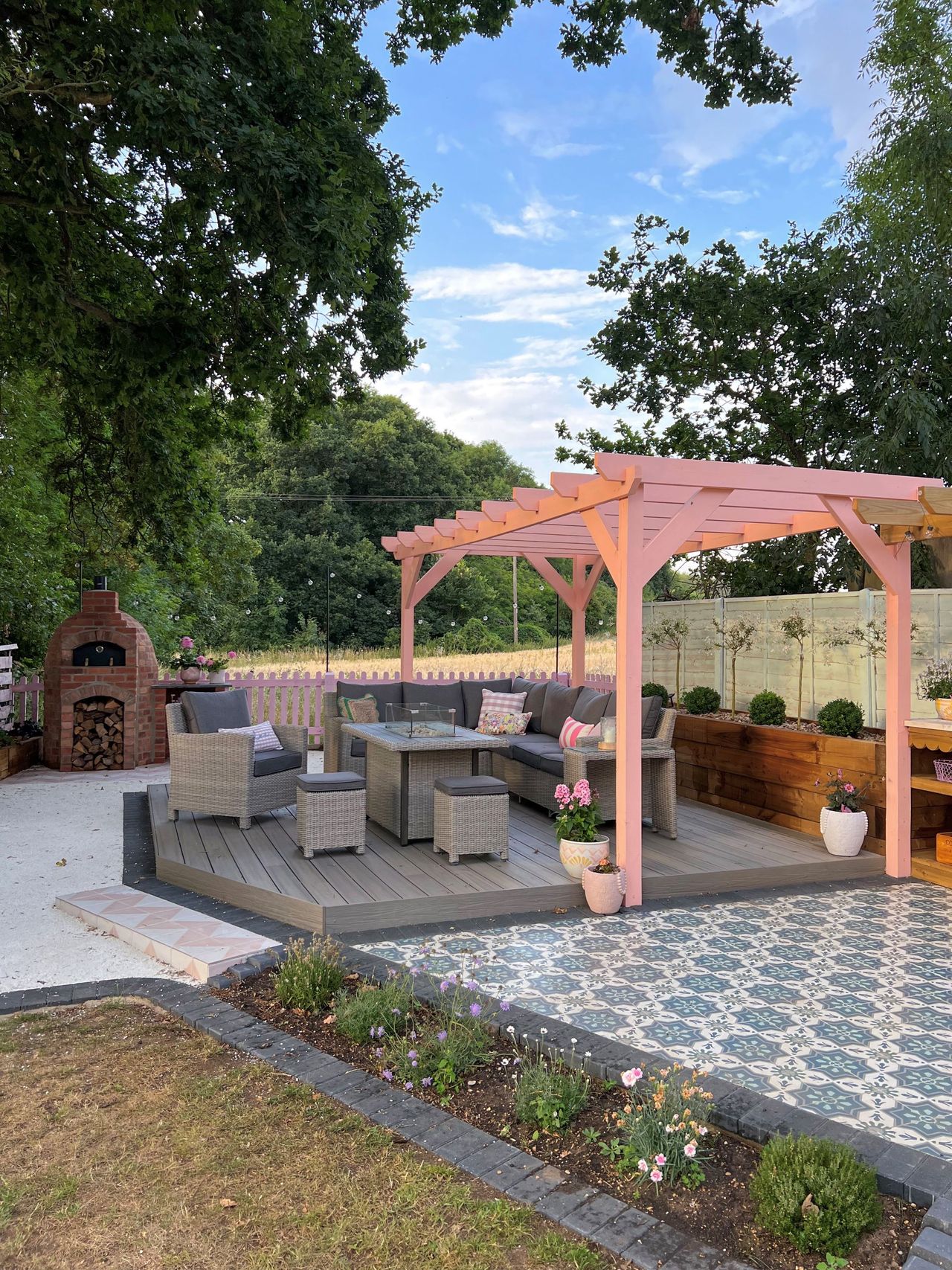 Outdoor firepit and play area with pink furniture