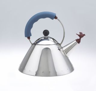 Silver kettle with maroon bird at the end of the spout
