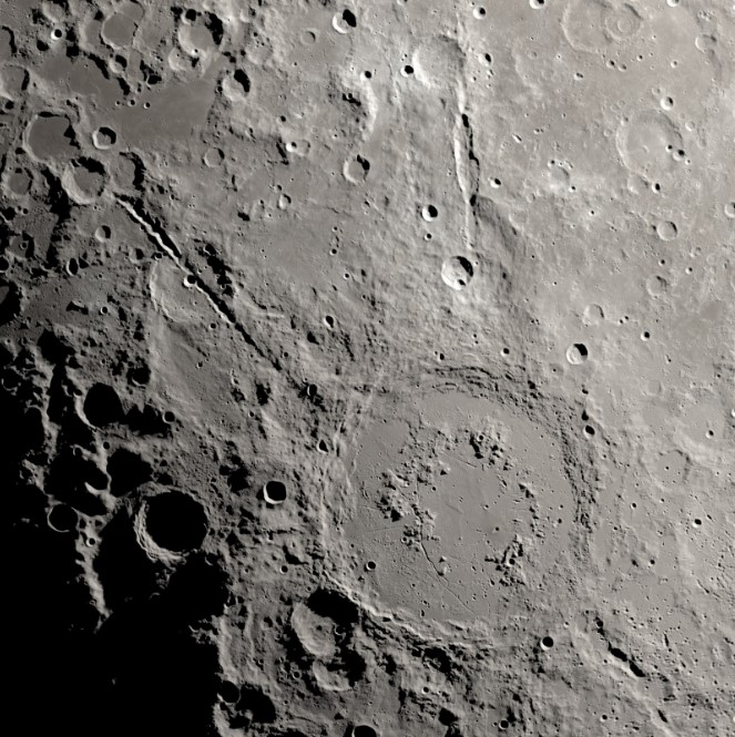 a rough and cratered landscape high above the moon.