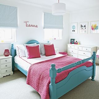 childrens room with white wall and blue bed and white chest