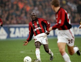 George Weah passes to an AC Milan team-mate in a derby against Inter in October 1999.
