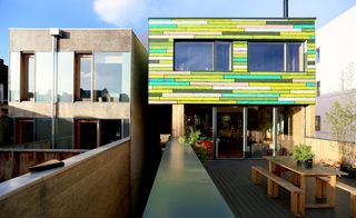 WoodBlock House - a brightly coloured wooden house with outside seating and dining