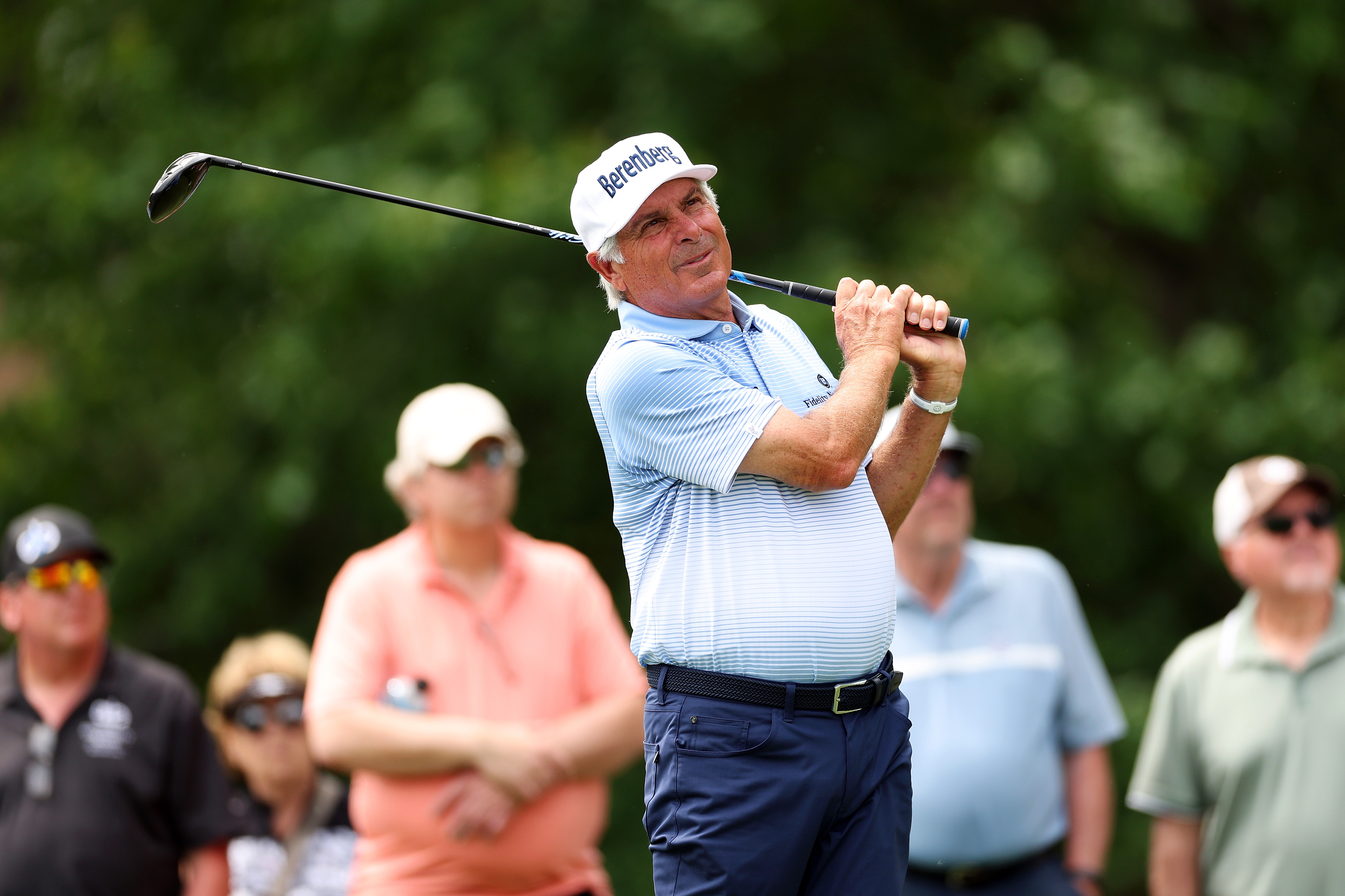 Fred Couples hits a tee shot and watches its flight