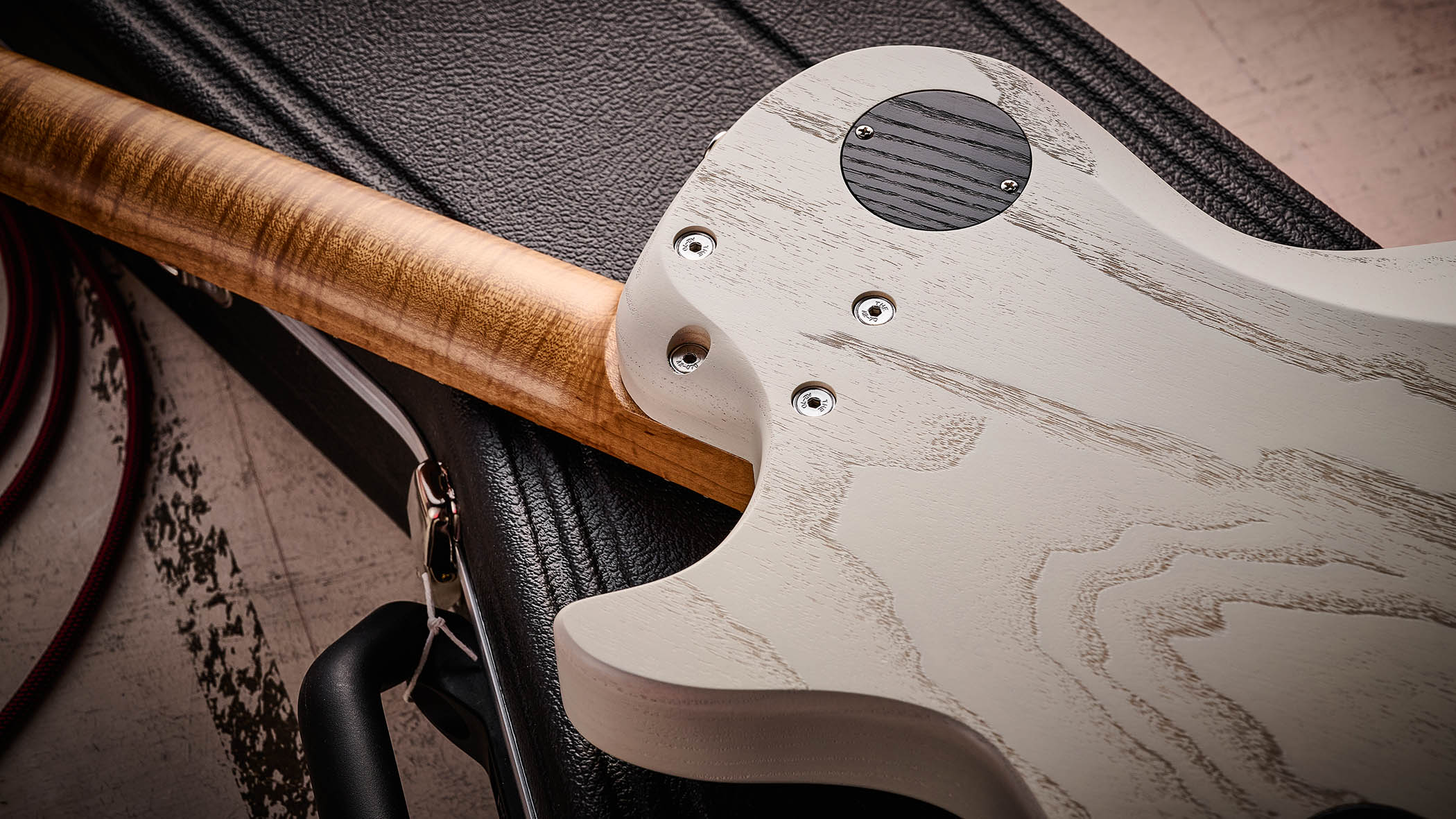 PJD Carey Classic: the translucent white singlecut has a handsome roasted figured maple neck, a black pickguard, and a P-90/Humbucker pairing.