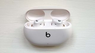 Beats Studio Buds Plus in their charging case in ivory with lid open