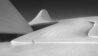 Child at the bottom of large modernist spiralling building