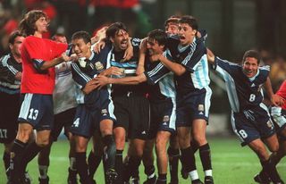 Argentina players celebrate with goalkeeper Carlos Roa after his saves in the shootout seal victory over England at the 1998 World Cup.