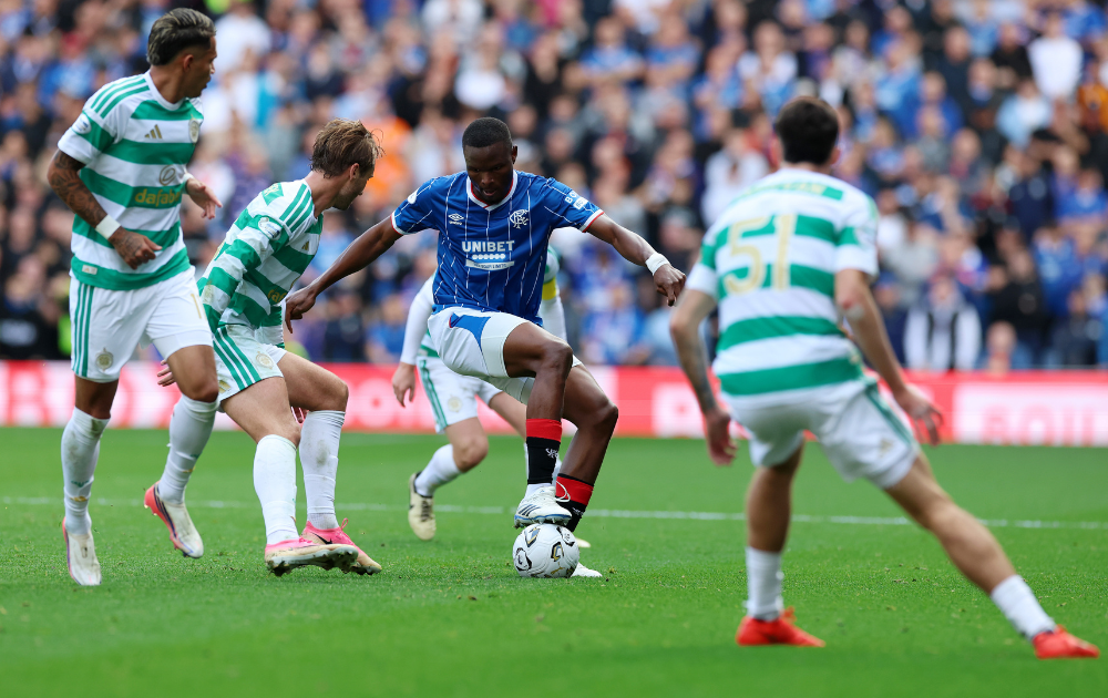 Olwethu Makhanya of Rangers in possession of the ball under pressure from Benjamin Nygren of Celtic during the Premier Sports Cup Quarter Final match between Rangers and Celtic at Ibrox Stadium on September 13, 2026 in Glasgow, Scotland.