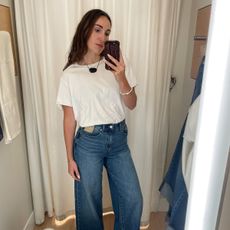 Anna LaPlaca wears a white T-shirt and wide-leg jeans from Madewell