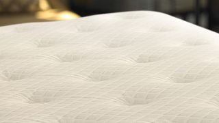 A close up of the damask quilted cover of the Sheraton hotel mattress