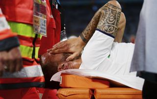 Italy’s Leonardo Spinazzola covers his face as he is carried off on a stretcher
