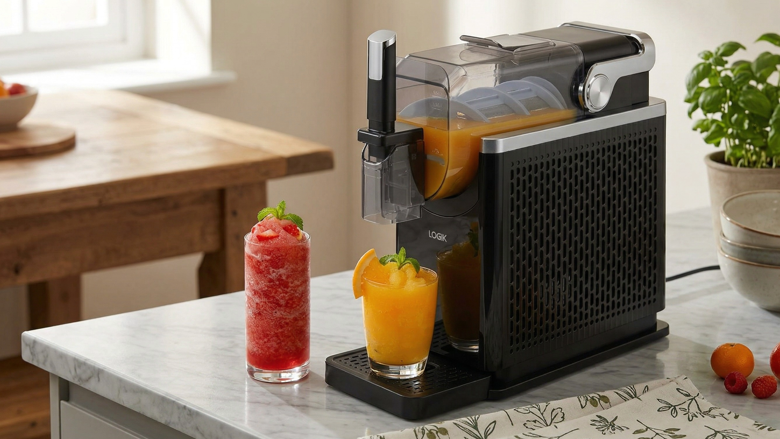 LOGIK's Slushi machine on a marble countertop with two frozen drinks 