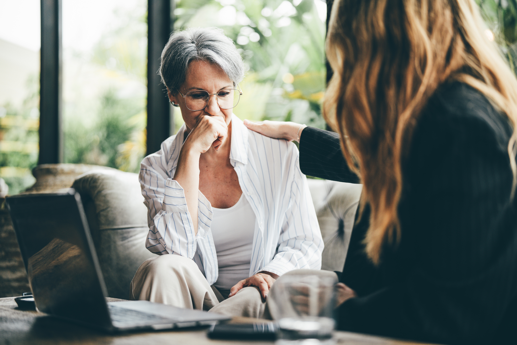 Two older women discussing finances