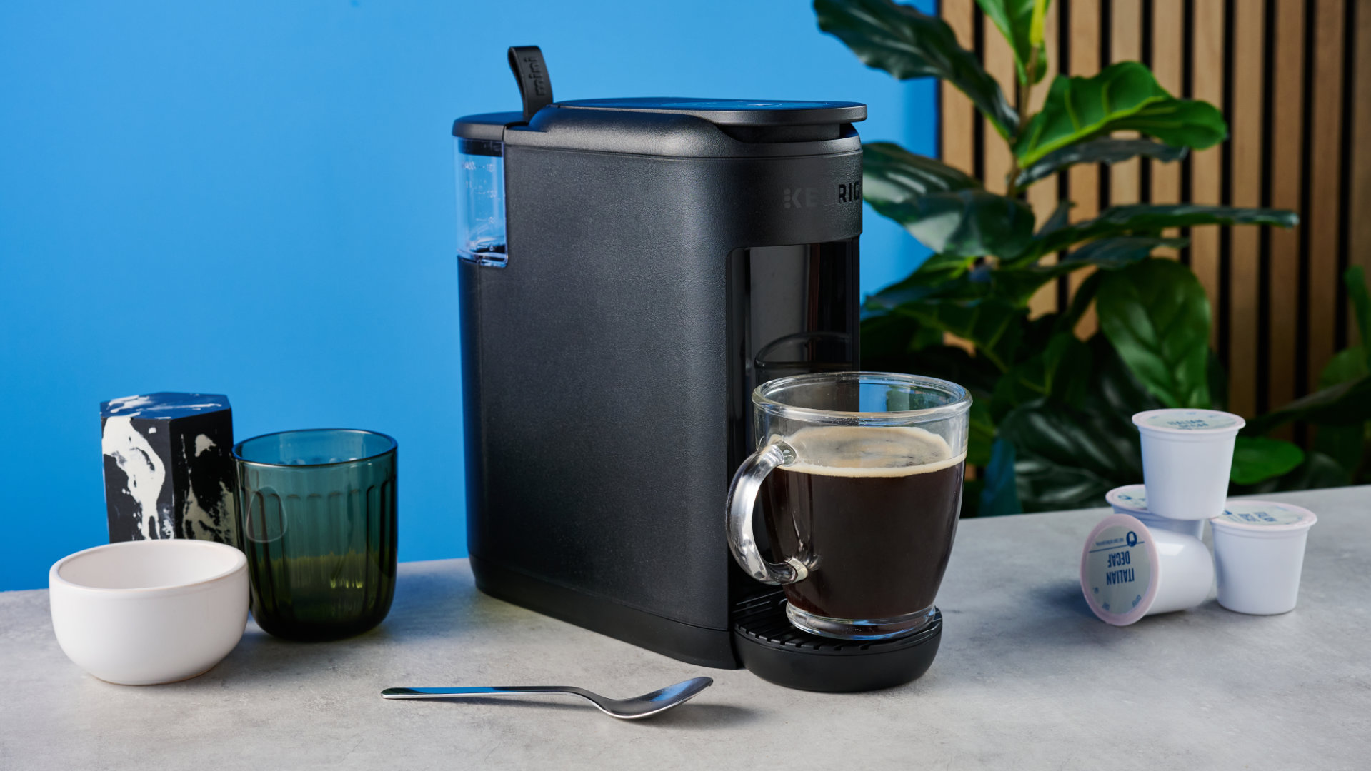 the keurig k-mini mate coffee maker photographed with the blue tom's guide background