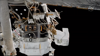 Spacewalkers Hague and Morgan install cables for the new docking port for the ISS.