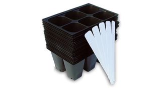 24 black seedling starter trays and plant labels