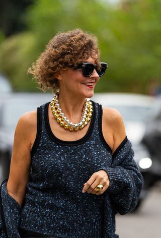 Milan fashion week spring 2025 street style photo of a woman wearing oversized jewelry trend