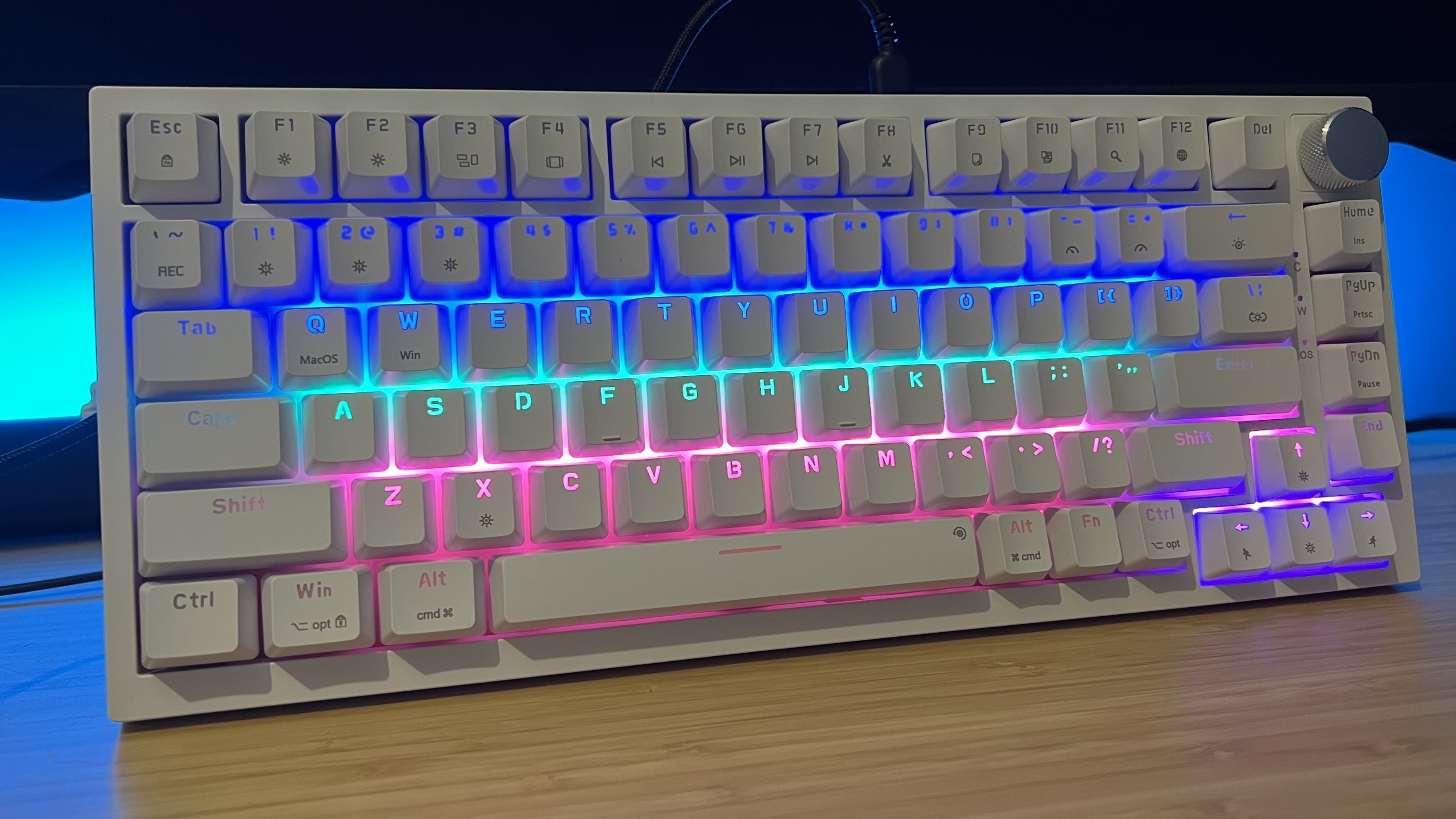 Newmen GM326 gaming keyboard on a wooden desk with RGB lighting on