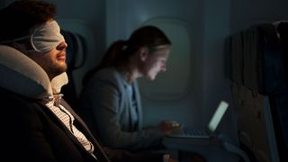 Man asleep on a plane