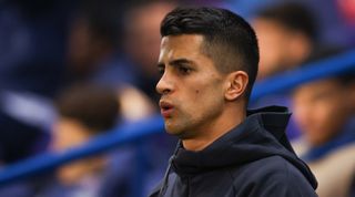 Joao Cancelo of Bayern Munich looks on from the touchline during the UEFA Champions League round of 16 match between PSG and Bayern Munich at the Parc des Princes on 14 February, 2023 in Paris, France.