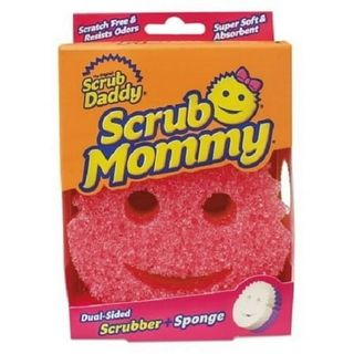 A pink smily face scrubbing sponge inside of a pink and orange cardboard box. 