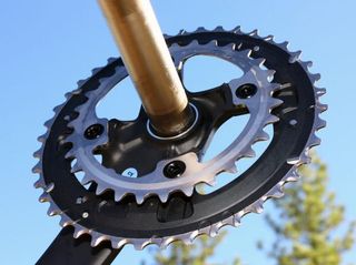 Dedicated two-ring cranks have no provision for an inner ring whatsoever and are also built with narrower pedal stance widths than the triple-ring cranks.