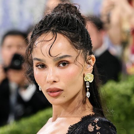 Zoe kravitz wears a black lace dress.