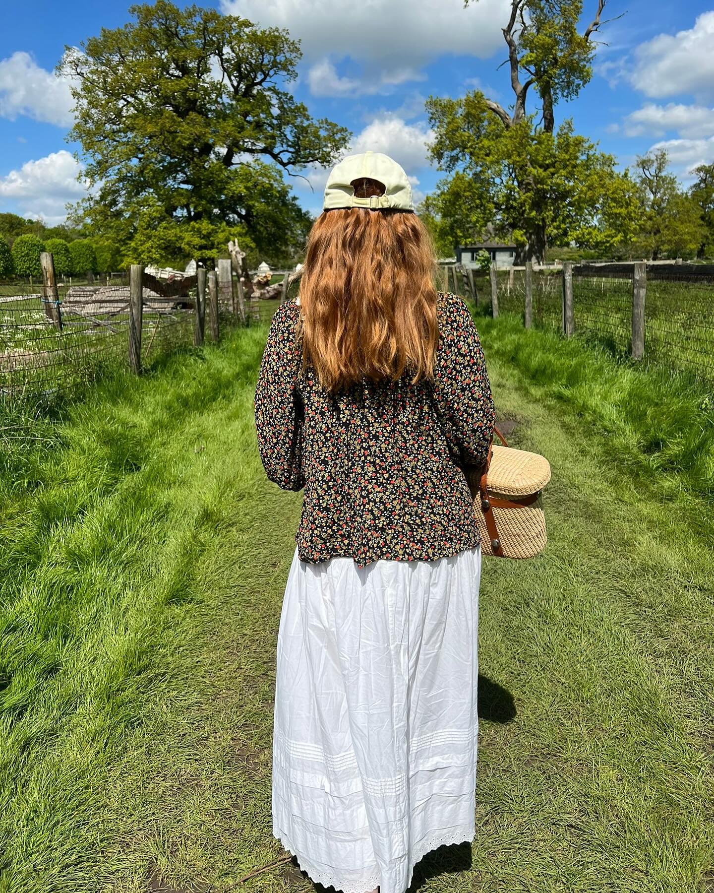 girl wearing a floral jacket and white dress