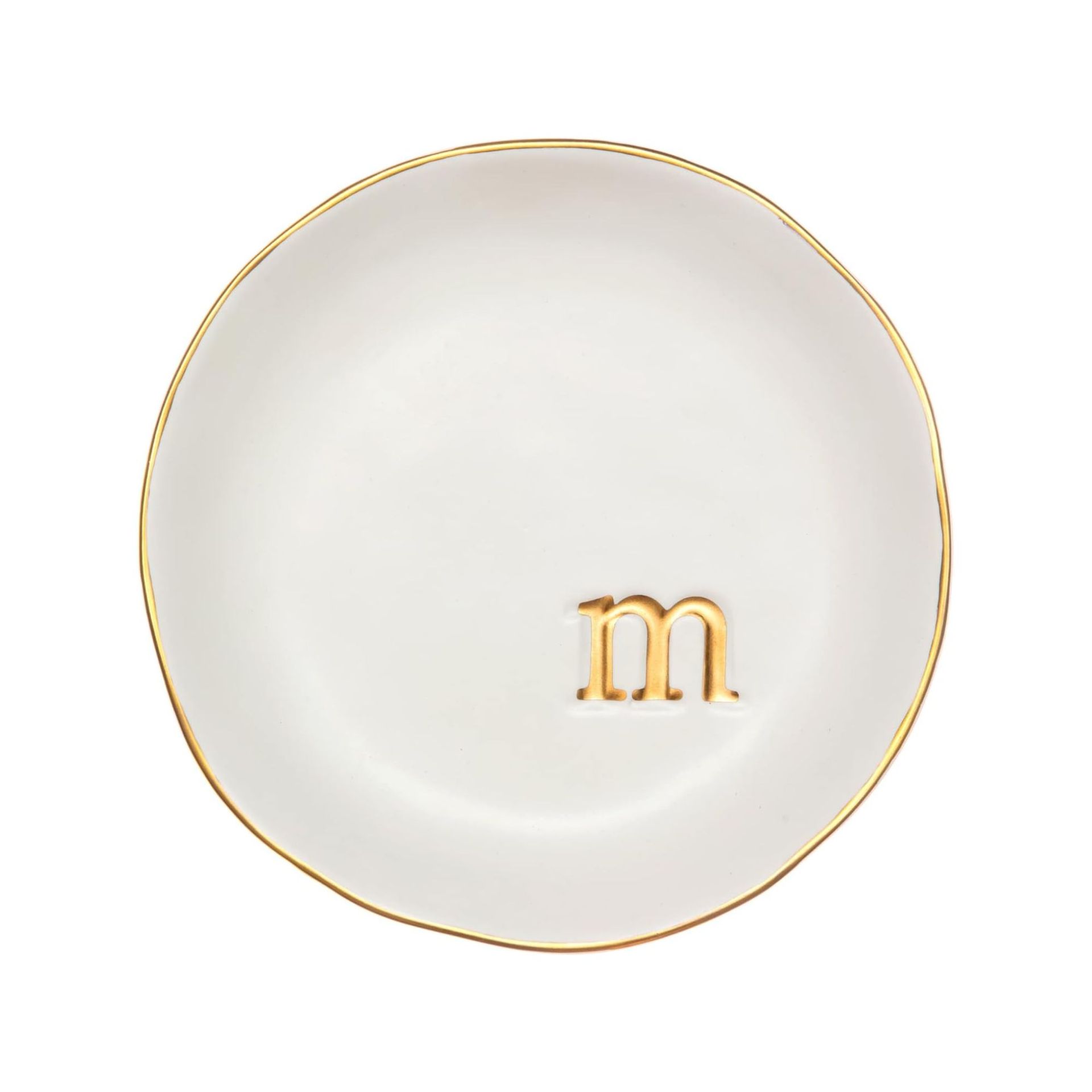 A round white trinket tray with a gold 'M' and border
