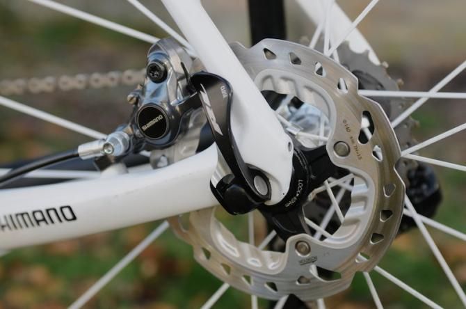 disc rotors will undoubtedly provide greater stopping power, though quick release wheels could cause rotor alignment issues.