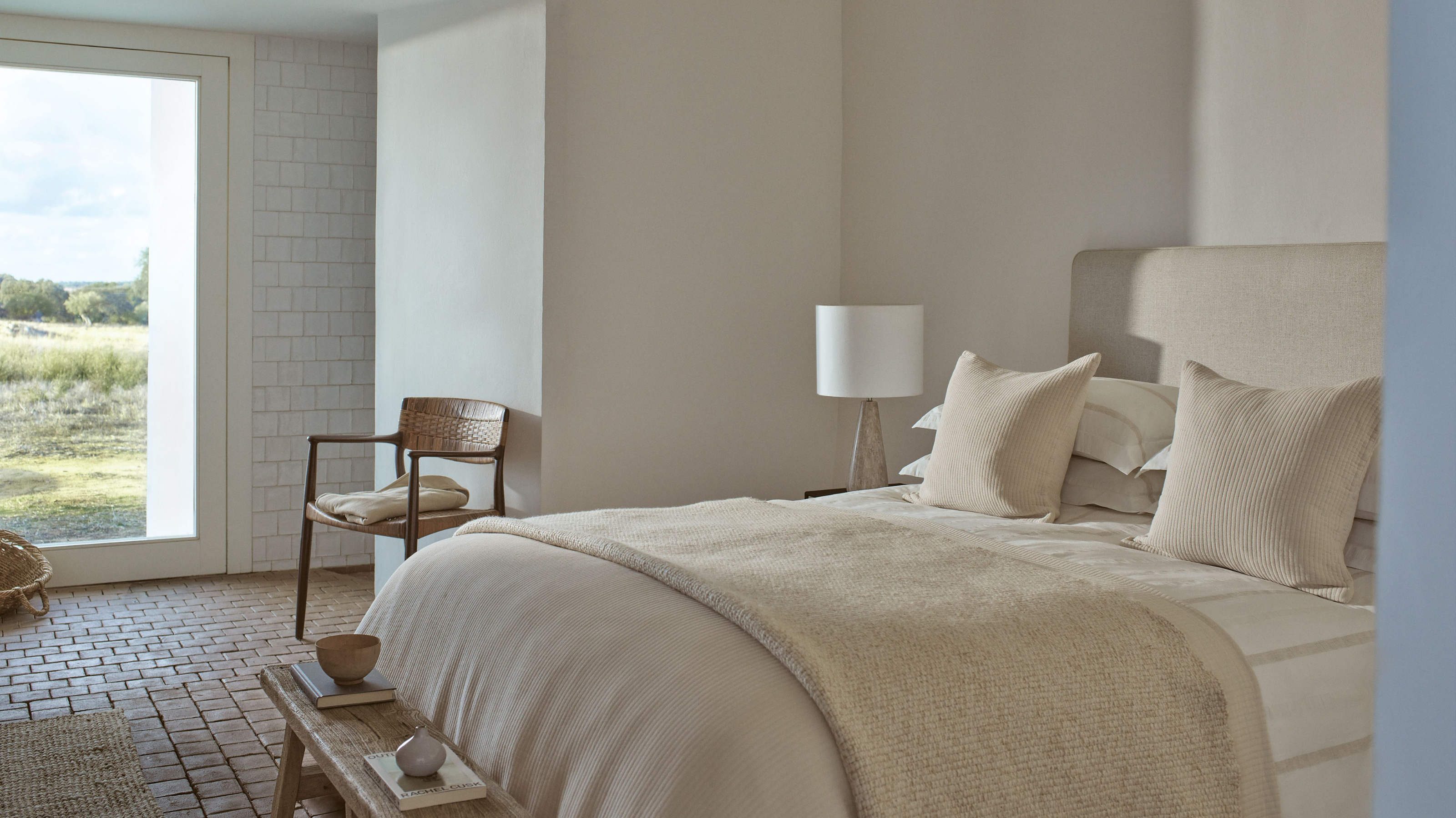 The White company bedding and Marlow table lamp in a modern, neutral bedroom.