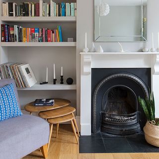 room with wooden flooring and fireplace and bookshelves